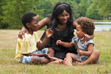 African mother and her kids are having fun in the natureの写真素材