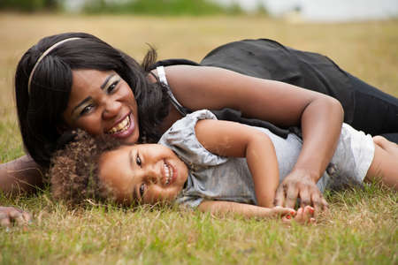 Pregnant mother and her daughter are having funの写真素材