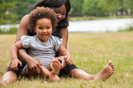 Pregnant mother and her daughter are having funの写真素材