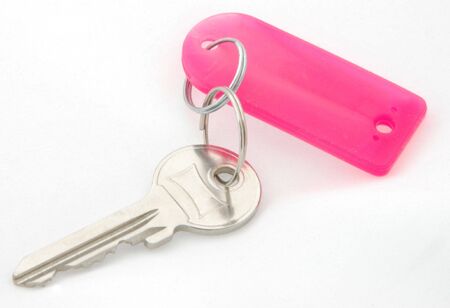 A house key on a pink tag. の写真素材