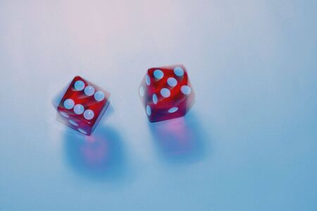 Action shot of two dice spinningの写真素材