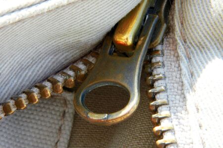 A macro closeup shot of a zipper and heavy weave cotton