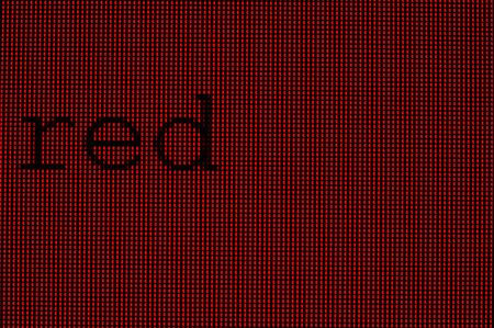 A macro image of the word "red" on a red LCD screenの写真素材