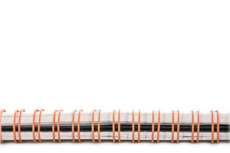 An isolated to white image of a notebook spiral spineの写真素材