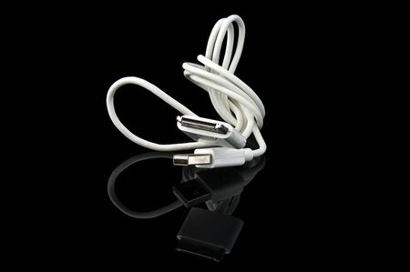 An isolated to black photo of a MP3 USB cable