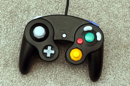 A video game console lying on a gray carpet