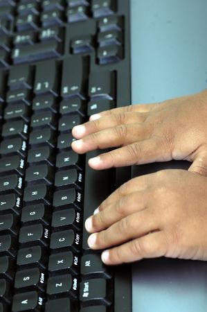 Hands typing on a computer key boardの写真素材