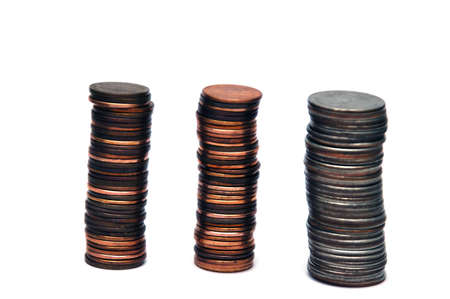 Piles of coins isolated on a white backgroundの写真素材