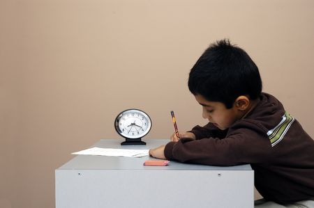 A child diligently taking a test on time