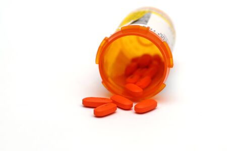Closeup shot of Red and white pills against a white backgroundの写真素材