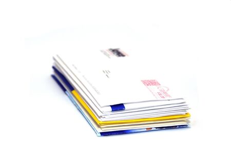 Pile of business letters isolated on white backgroundの写真素材