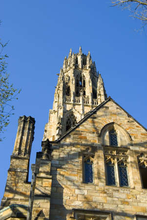 An old college tower against a blue skyの写真素材