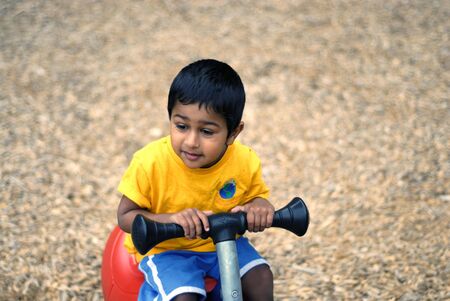 an handsome Indian child happy playing in the play areaの写真素材