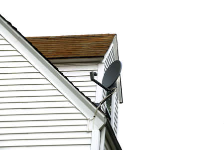 A satellite dish on a roof top against a white back groundの写真素材