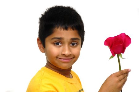 Happy Indian kid holding a rose for valentineの写真素材