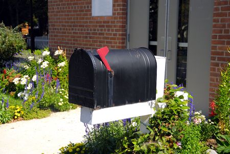 An old mail box in front of a brick building