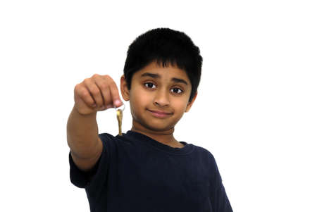 An handsome Indian kid handing over keysの写真素材