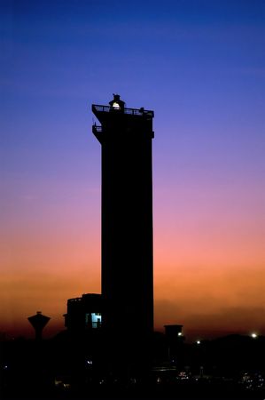 A modern lighthouse beautifully lit at dusk timeの写真素材