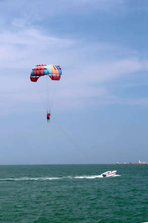 One man is parasailing over the clean sea.の写真素材