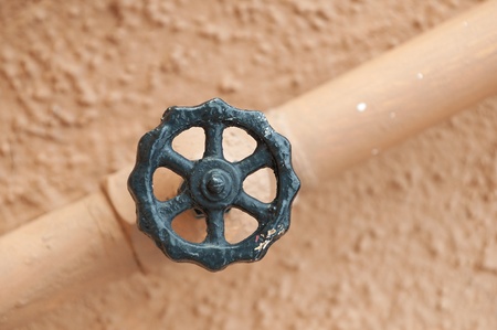 value and pipe isolated against a light wall background