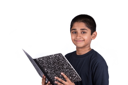 A handsome Indian kid doing his homework diligentlyの写真素材