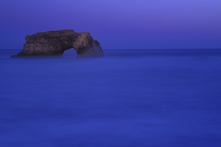 Natural Bridges rock in the Beach of Santa Cruz, California, USA. With ocean wave in the foreground.の写真素材