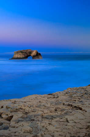 Natural Bridges rock in the Beach of Santa Cruz, California, USA. With ocean wave in the foreground.