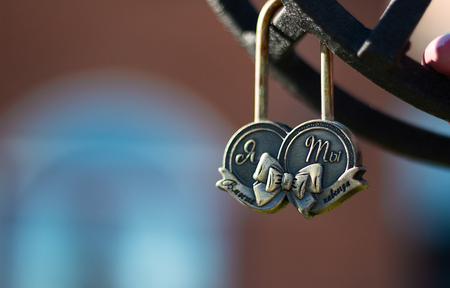 Wedding lock on a metal fencing on bridge in park Symbol of Loveの写真素材