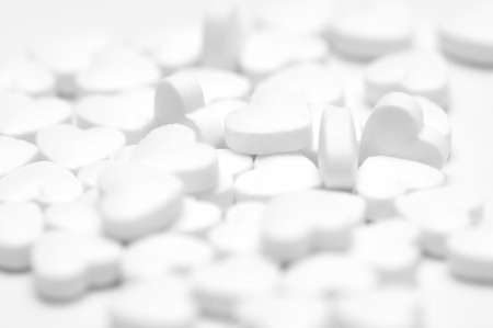 White pills on white background
