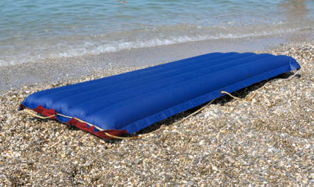 blue inflatable raft on the sand sea beachの写真素材