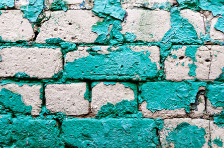 old brick wall texture background with worn off paintの写真素材