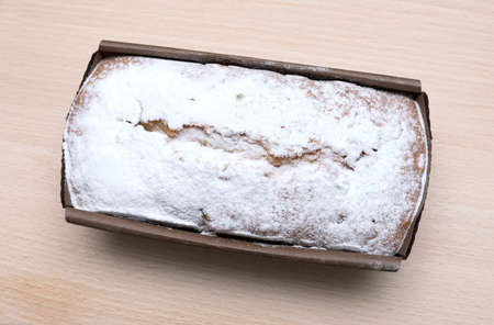 Ruddy rectangular cake on a wooden boardの写真素材