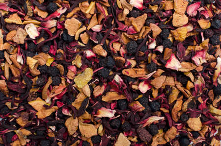 aromatic black dry tea with fruits and petals, isolated on whiteの写真素材