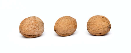 three walnuts close up isolated on white backgroundの写真素材