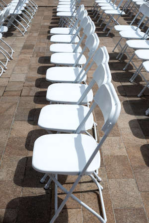 rows of folding chairs at eventの写真素材