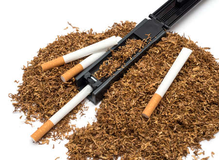 Cigarette rolling machine and empty cigarette tube and tobacco on white backgroundの写真素材