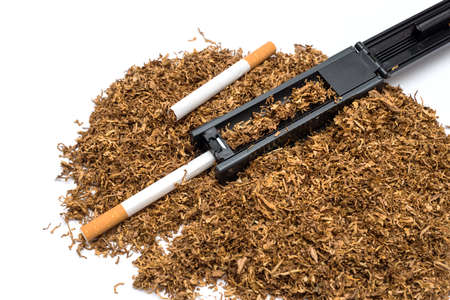 Cigarette rolling machine and empty cigarette tube and tobacco on white backgroundの写真素材
