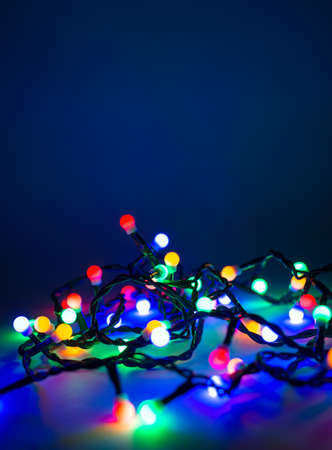 Christmas lights over dark blue backgroundの写真素材