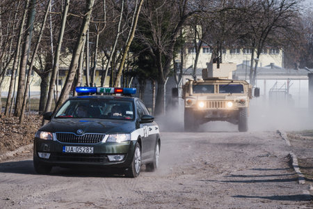 Lublin, Poland - March 25, 2015: United States Army vehicle (Armored Personnel Carrier) Humvee passing city streetsのeditorial素材