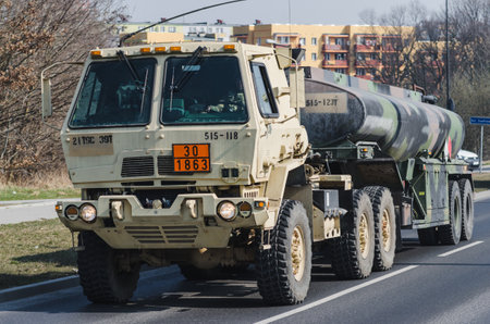 Lublin, Poland - March 25, 2015: United States Army Oshkosh refuel Medium Tactical Vehicle passing city streetsのeditorial素材