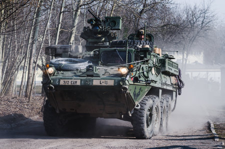 Lublin, Poland - March 25, 2015: United States Army vehicle (Armored Personnel Carrier) Stryker passing city streetsのeditorial素材