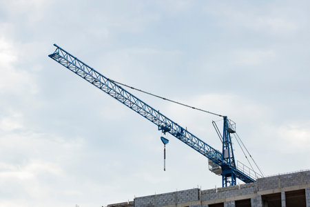 Crane on the background of a cloudy sky. Construction of storey buildings.の写真素材