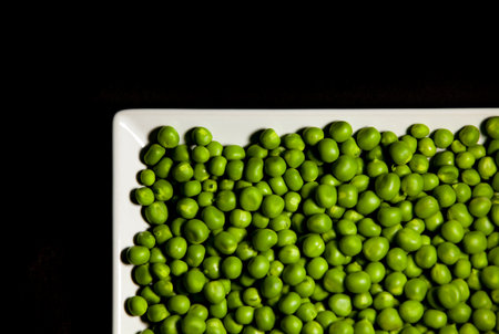 Green peas on dark. Saturated background. Top view, copy space.の写真素材