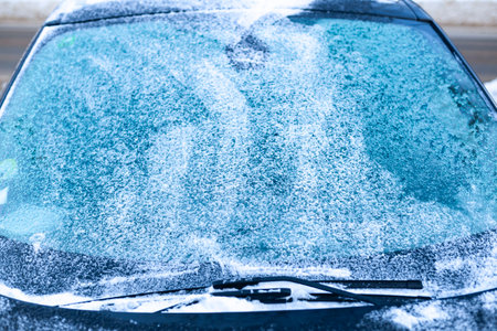 Icy windshield, wipers and hood.Winter car difficulties concept.の写真素材