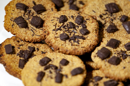 Oat cookies with chocolate. A pile of homemade cookies on the table. Selective focus. Top view.