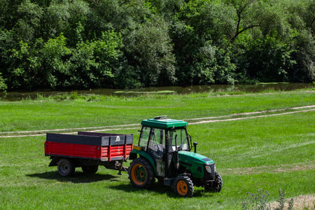 Tractor against a picturesque landscape with river and hillsの写真素材
