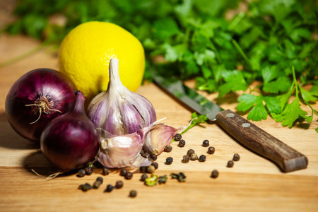 Fresh kitchen still life with lemon, red onions, garlic and parsley - rustic ingredients for homemade cooking.の写真素材