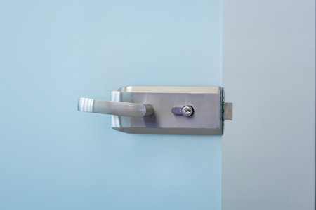 Modern glass door handle. Contemporary design element, modern architecture close-up with copy space.