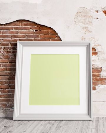 3d blank white picture frame with brick wall and wooden floor  3D illustrationの写真素材