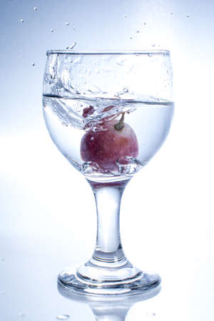 art of throwing grape into the waterの写真素材